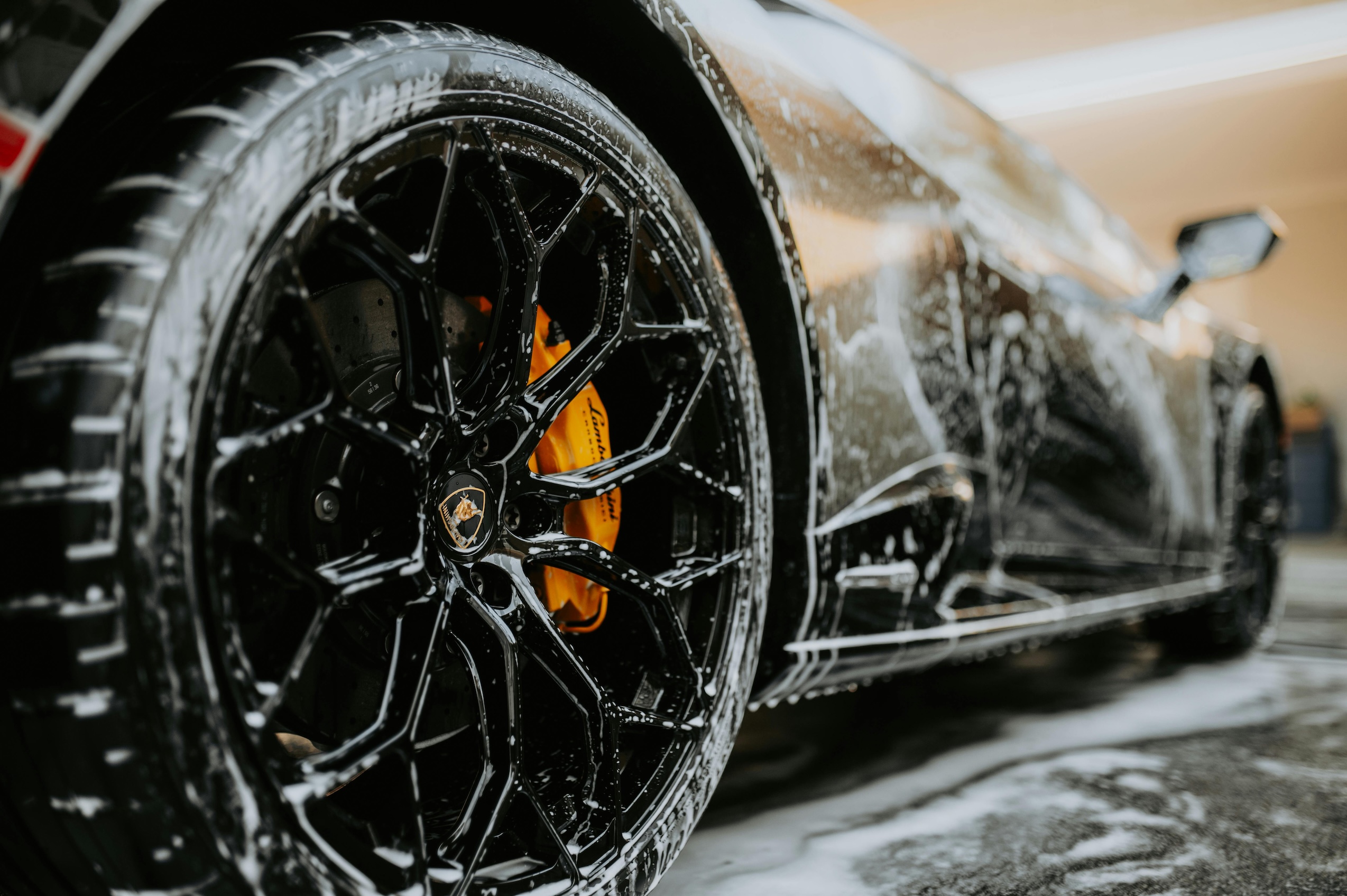 Close-up of a premium black alloy wheel on a car